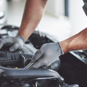 Auto mechanic working in garage. Repair service