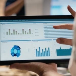 Woman property engineer searching layout details on laptop in the office, working on urban development for a residential construction project in innovation hub. Construction site.