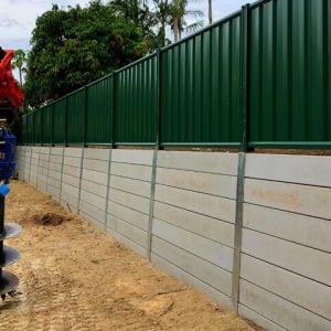 A worker retaining walls and Fencing a home garden