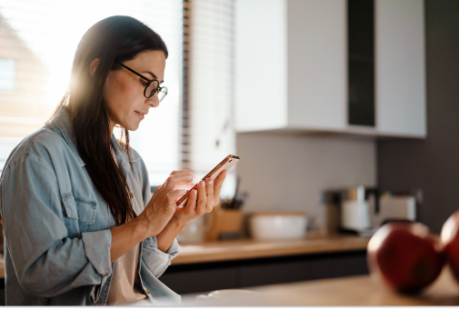 A woman looking at her phone for options about her fertility