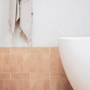 A beautiful tiled bathroom with a bath