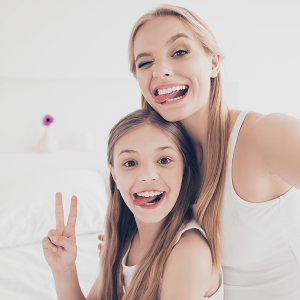 Happy loving mother with smiling little child girl