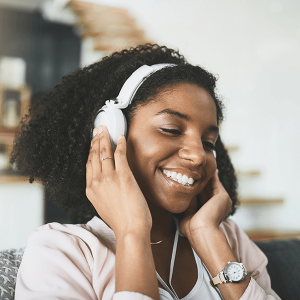Woman using headphones and smiling