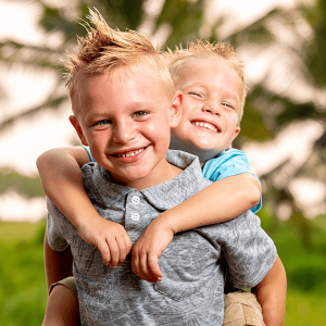 Two funny smiling little children, showing their teeth