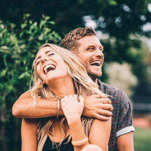 Man is smiling and hugging his friend