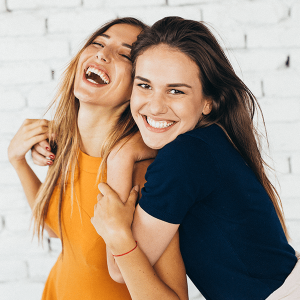 Beautiful young women smiling together