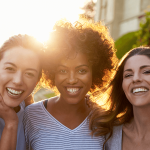 Portrait of three young adult female friends in the street