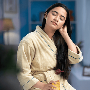 Woman applying oil on hair